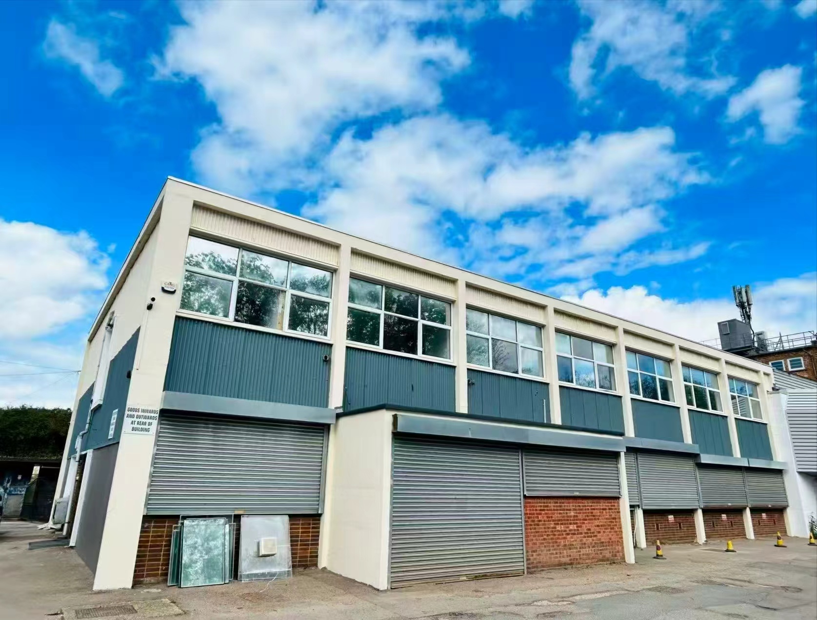 The exterior of a FrontX warehouse with goods-in shutter doors
